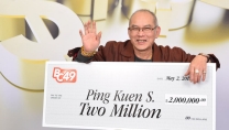 Ping Kuen Shum holding big cheque